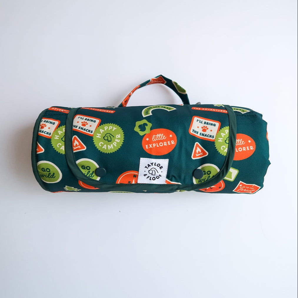 Happy Camper settle mat by Taylor and Floof, rolled for travel, waterproof and non-slip.