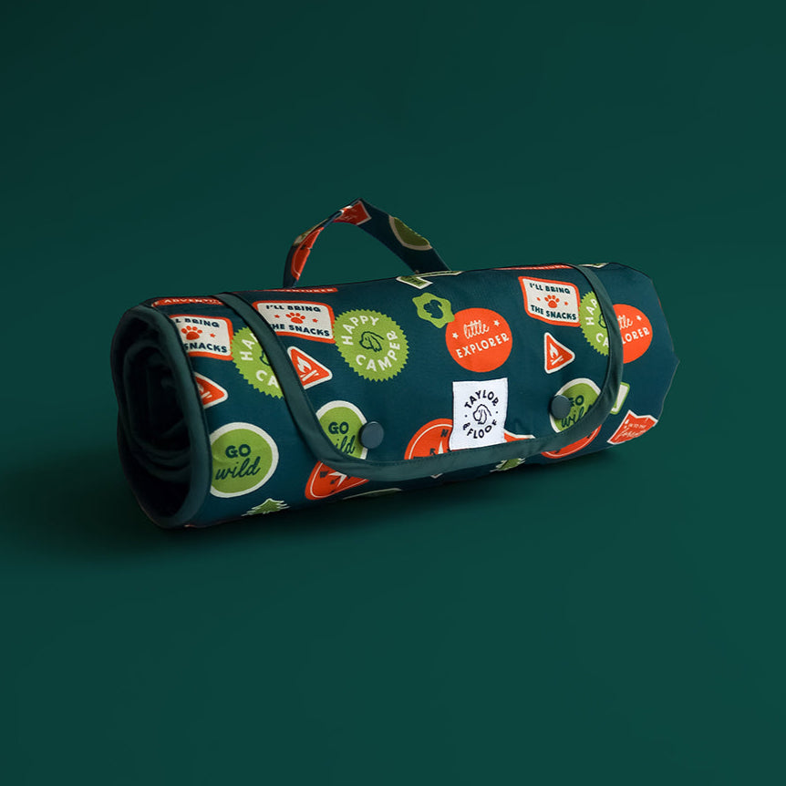 Rolled Happy Camper dog settle mat in green with waterproof lining and settle training design.
