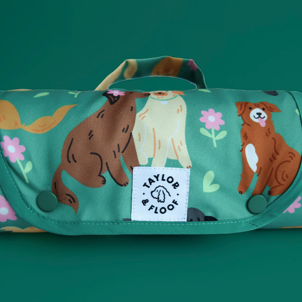 Close-up of dark teal dog mat showing detailed retriever illustrations including labs, goldens, tollers, and flat coat retrievers.