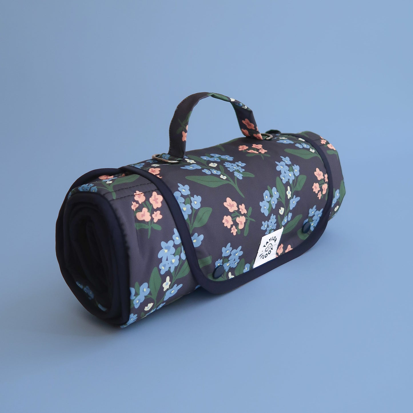 Dark Blue dog travel mat with blue and pink flowers on. Perfect for dogs who need help to settle in public.