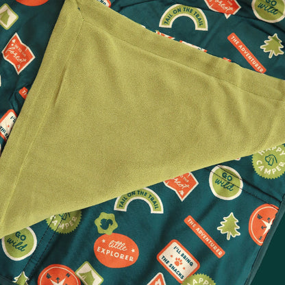 Green fabric with a pattern of colorful text and shapes on a teal background