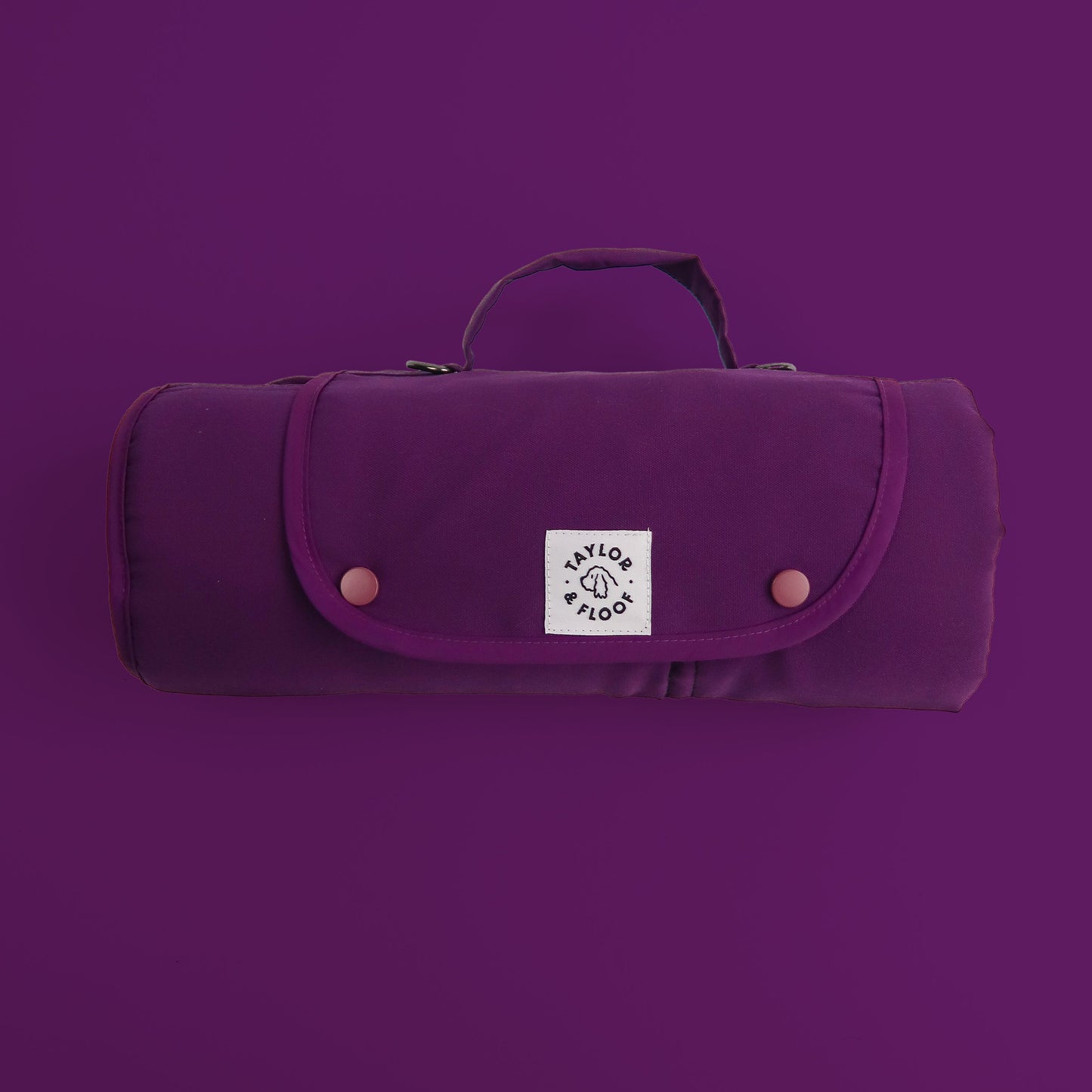 Purple settle mat rolled with a logo on a matching purple background