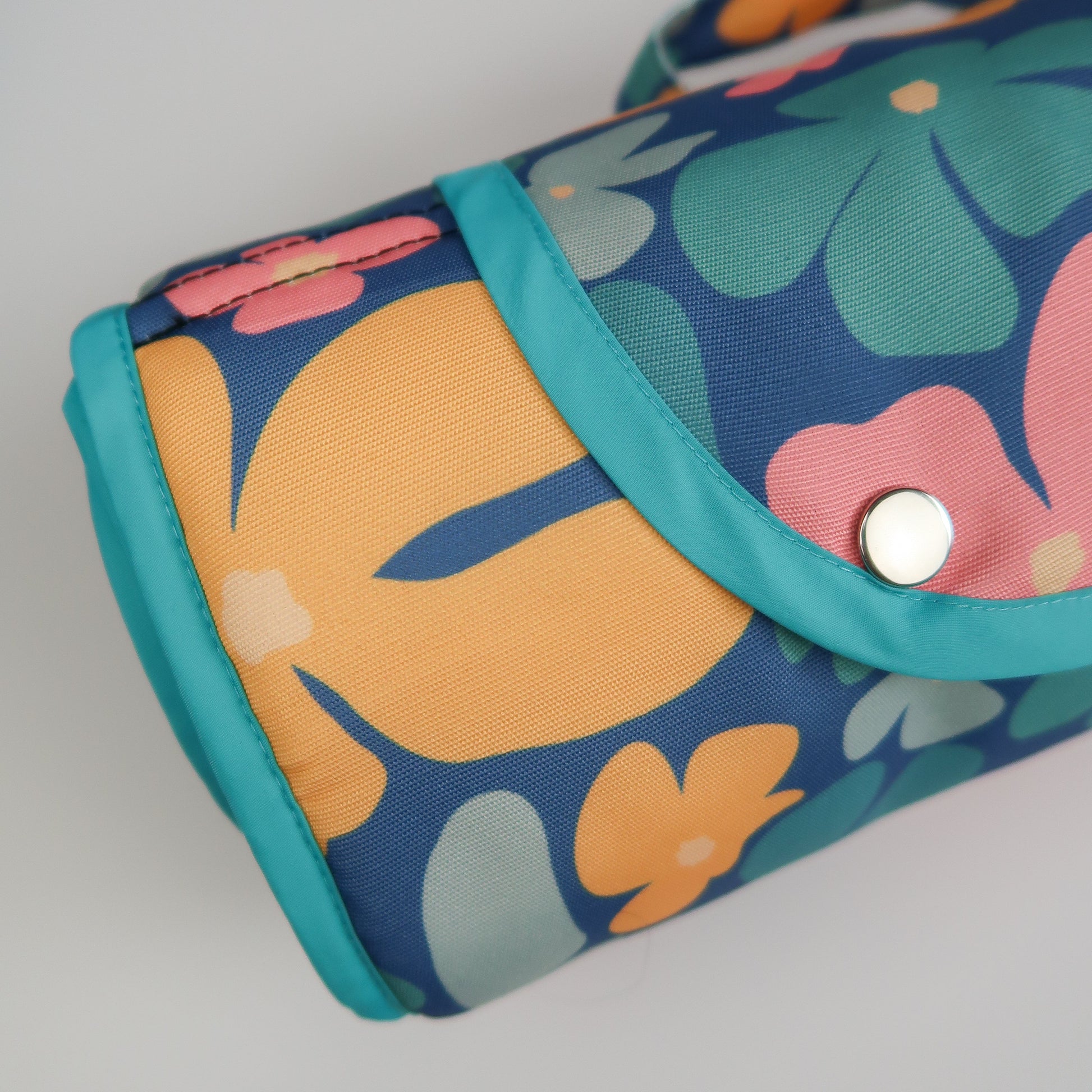 Blooming Wild Taylor and Floof Settle mat. Popper closure settle mat. Close-up of the Blooming Wild settle mat for dogs, featuring multi coloured floral patterns designed with dog vision in mind