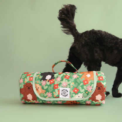 Cockapoo settle mat rolled up with a cockapoo walking in the background. A must-have calm training mat for dog parents who want comfort and aesthetic design.