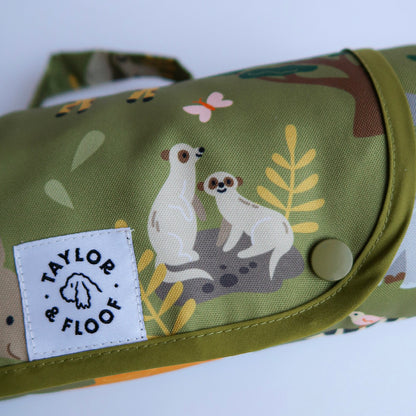 Foldable and portable dog mat with safari animal illustrations, perfect for training and travel. Hero shot of the settle mat with meerkats. 