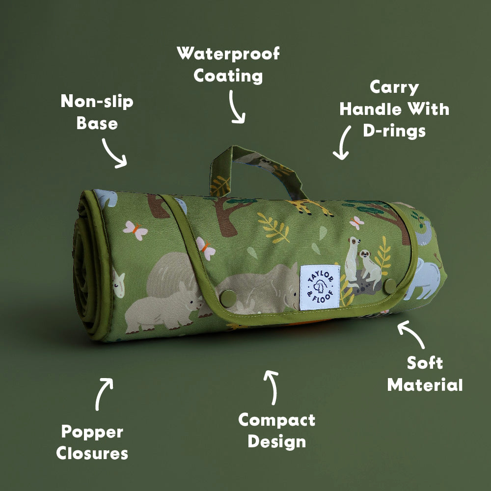 Roll-up do settle mat with safari animal pattern on a green background, featuring text labels about its features.