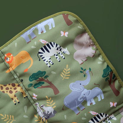 Close-up of safari animal dog mat featuring elephants, rhinos, giraffes, lions, and meerkats on soft, wipeable fabric.